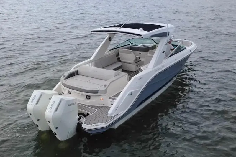 Slide: The Image of 2024 Sea Ray SLX 310 Outboard boat on water, featuring sleek design and dual engines. - 6