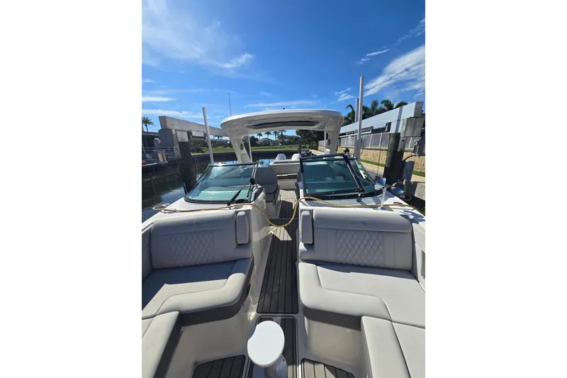 Slide: The Image of 2024 Sea Ray SLX 310 Outboard boat interior with luxurious seating and sleek design. - 8