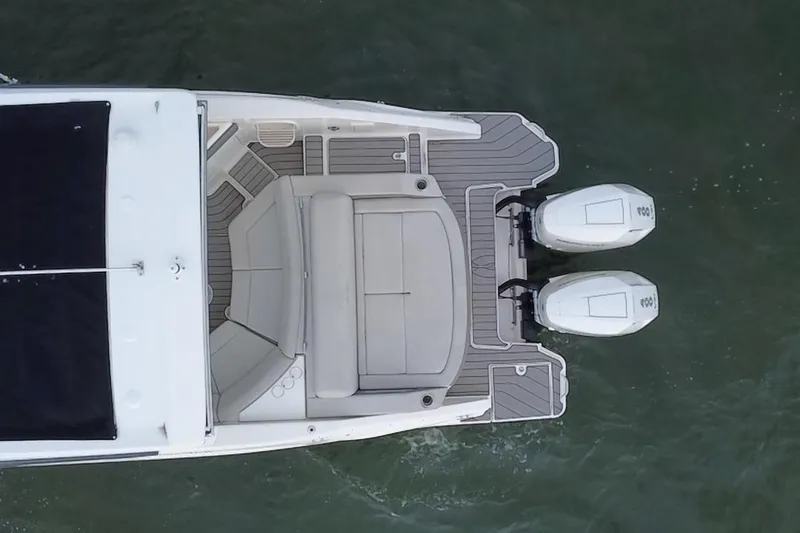 Slide: The Image of 2024 Sea Ray SLX 310 Outboard, aerial view, showcasing dual engines and spacious deck. - 15