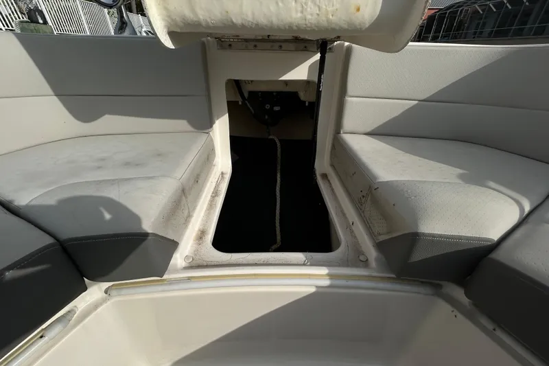 Slide: The Image of 2024 Sea Ray SLX 310 Outboard interior seating area with storage compartment. - 96