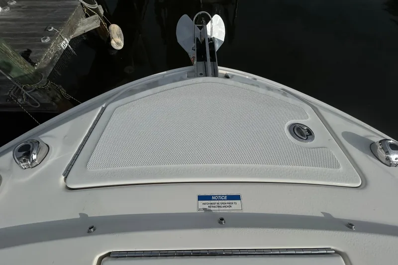 Slide: The Image of 2024 Sea Ray SLX 310 Outboard bow with anchor hatch and dock view. - 98