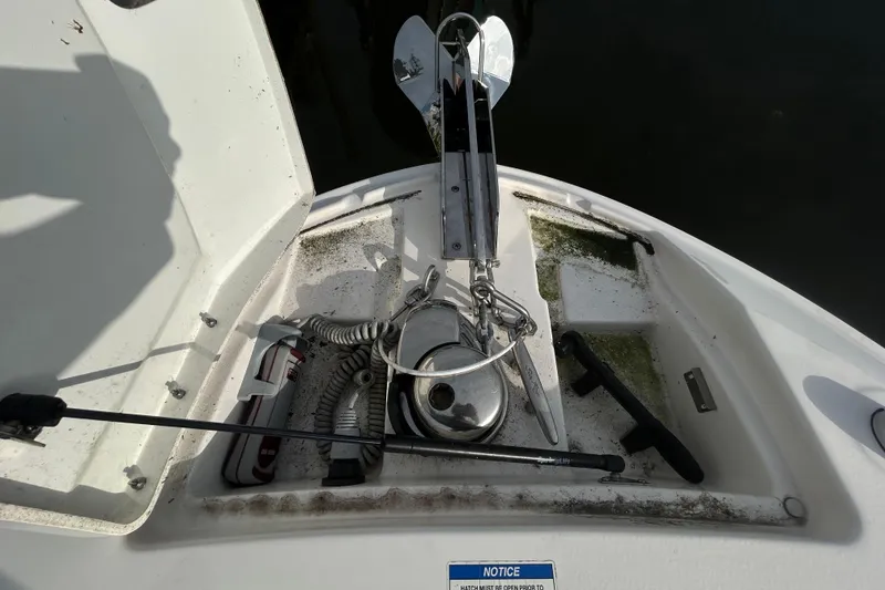 Slide: The Image of 2024 Sea Ray SLX 310 Outboard anchor storage with equipment and accessories. - 99
