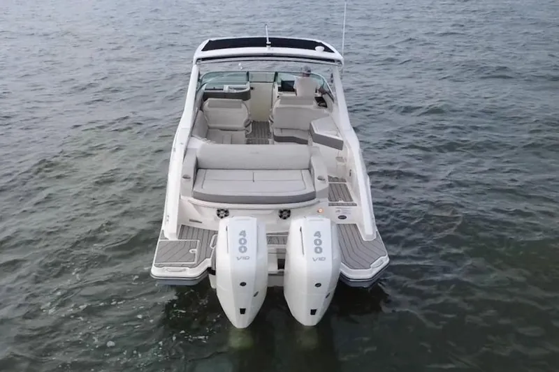 Slide: The Image of 2024 Sea Ray SLX 310 Outboard boat on water, rear view with dual engines. - 5