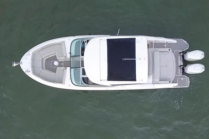 Slide: The Image of Aerial view of a 2024 Sea Ray SLX 310 Outboard on calm water. - 16