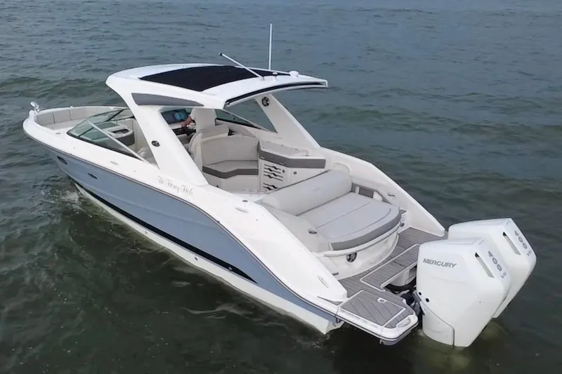 Slide: The Image of 2024 Sea Ray SLX 310 Outboard boat cruising on open water. - 4