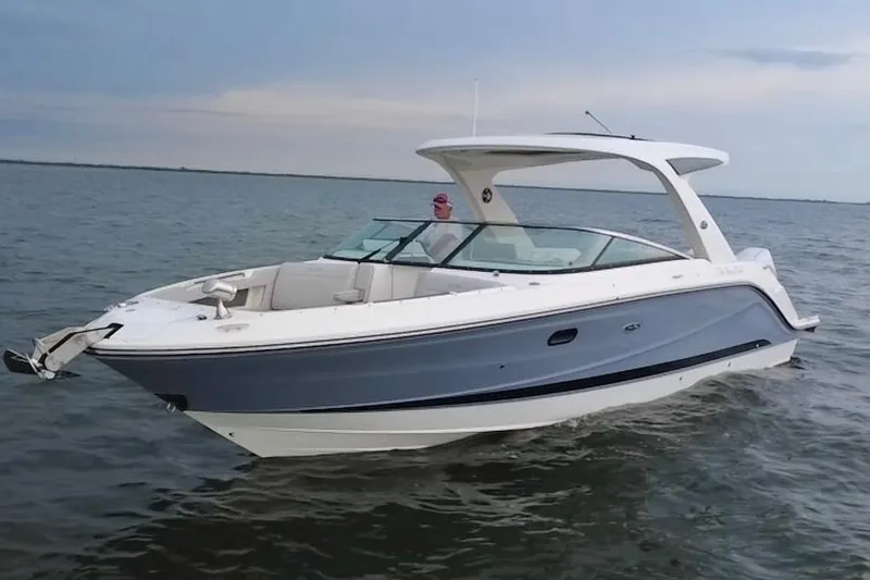 The Image of 2024 Sea Ray SLX 310 Outboard boat cruising on open water. - 0