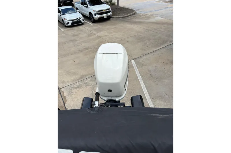 Slide: The Image of Top view of a 2018 Regency 254 LE3 Sport boat engine in a parking lot. - 19