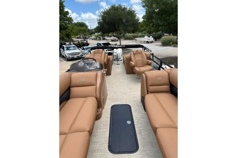 Slide: The Image of 2018 Regency 254 LE3 Sport pontoon boat with tan seating and spacious deck. - 2