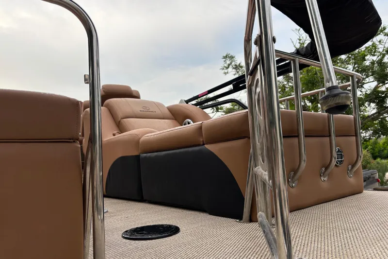 Slide: The Image of 2018 Regency 254 LE3 Sport boat interior with tan seating and metal railings. - 5