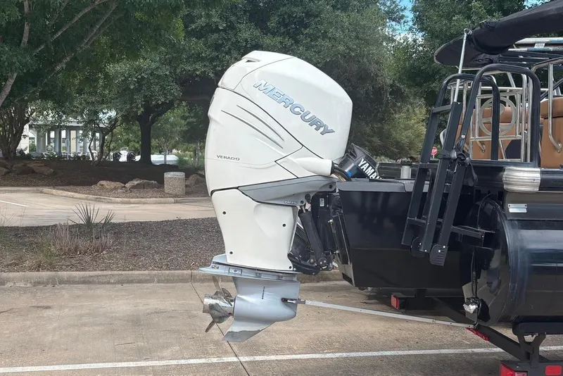 Slide: The Image of A Mercury boat engine on a trailer, surrounded by trees. - 6