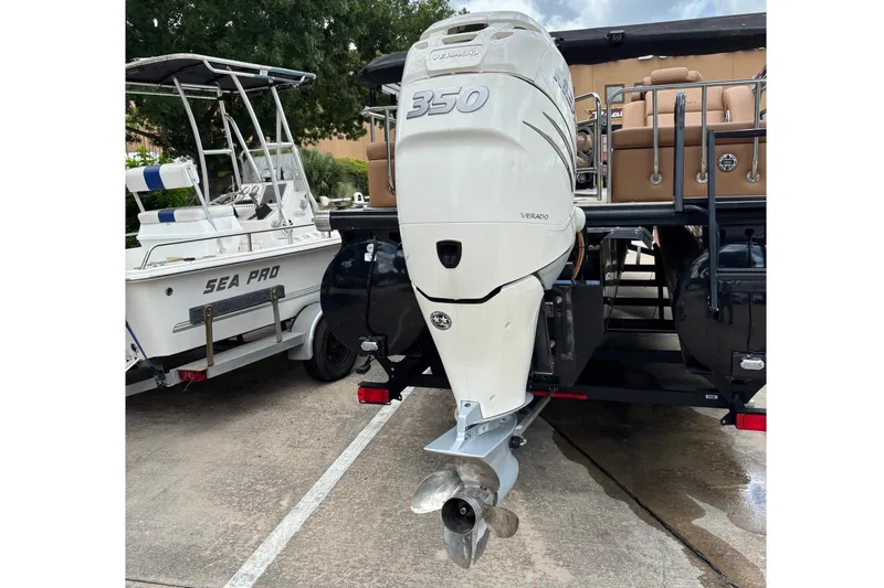 Slide: The Image of A boat with a large outboard motor parked on a trailer. - 7