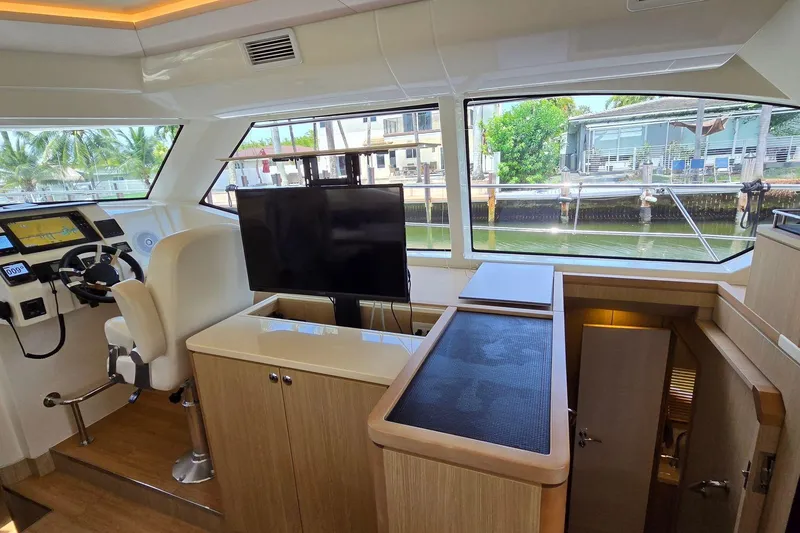 Slide: The Image of Interior of 2020 Aquila 44 Yacht with helm, seating, and large windows. - 12