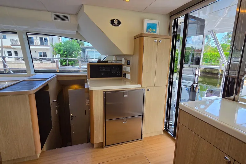Slide: The Image of Interior of 2020 Aquila 44 Yacht featuring modern kitchen and outdoor view. - 13