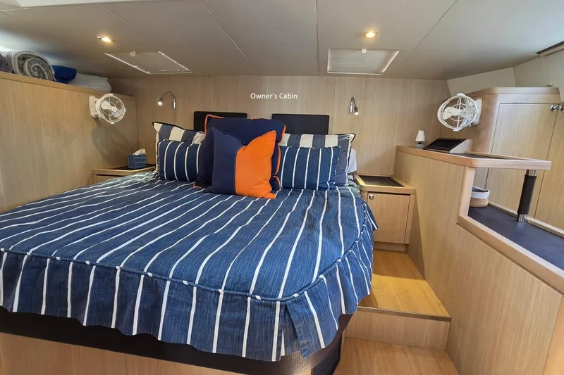 Slide: The Image of Owner's cabin in 2020 Aquila 44 Yacht with striped bedding and modern decor. - 14
