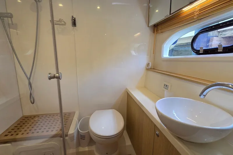 Slide: The Image of Bathroom interior of 2020 Aquila 44 Yacht with shower, toilet, and sink. - 18
