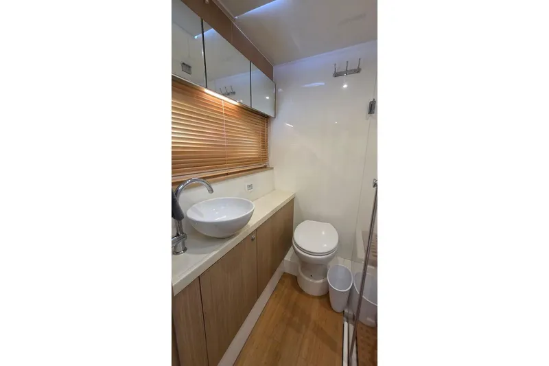 Slide: The Image of Modern bathroom interior on 2020 Aquila 44 Yacht with sink, toilet, and wooden accents. - 19