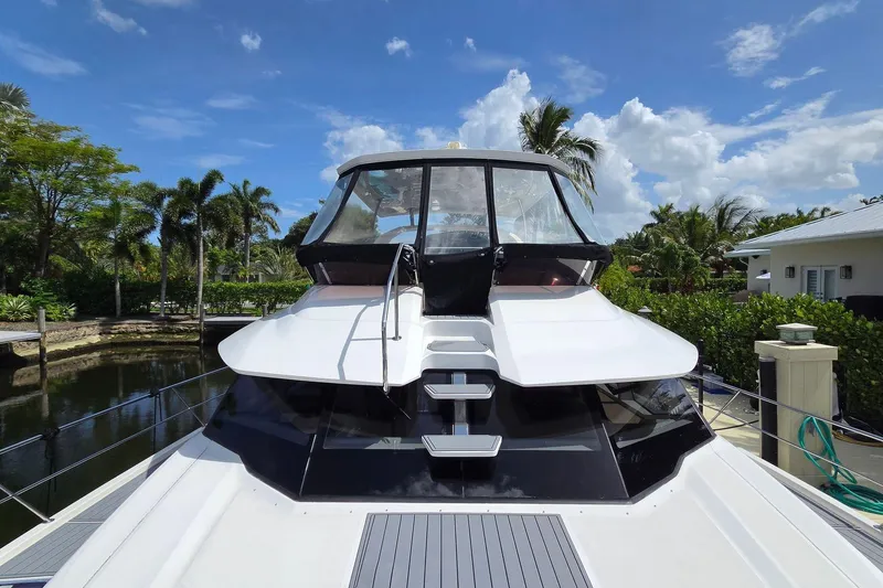 Slide: The Image of 2020 Aquila 44 Yacht docked, surrounded by lush greenery and clear blue sky. - 2