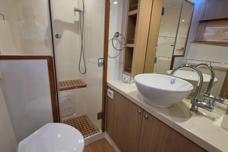 Slide: The Image of Luxury bathroom in 2020 Aquila 44 Yacht with modern fixtures and wooden accents. - 20