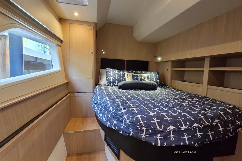 Slide: The Image of Port guest cabin of 2020 Aquila 44 Yacht with nautical-themed bedding. - 21