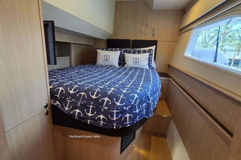 Slide: The Image of Starboard guest cabin in 2020 Aquila 44 Yacht with nautical-themed bedding. - 22