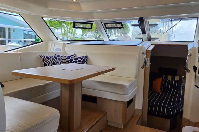 Slide: The Image of Interior of 2020 Aquila 44 Yacht with seating, table, and cabin view. - 24