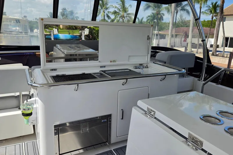 Slide: The Image of Luxury outdoor kitchen on 2020 Aquila 44 Yacht, featuring grill and storage. - 35