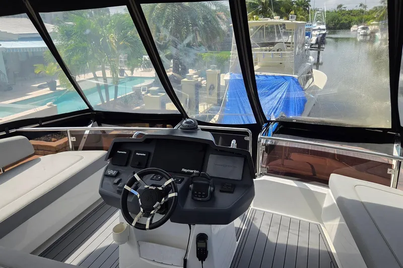 Slide: The Image of Cockpit view of 2020 Aquila 44 Yacht with steering wheel and navigation controls. - 37