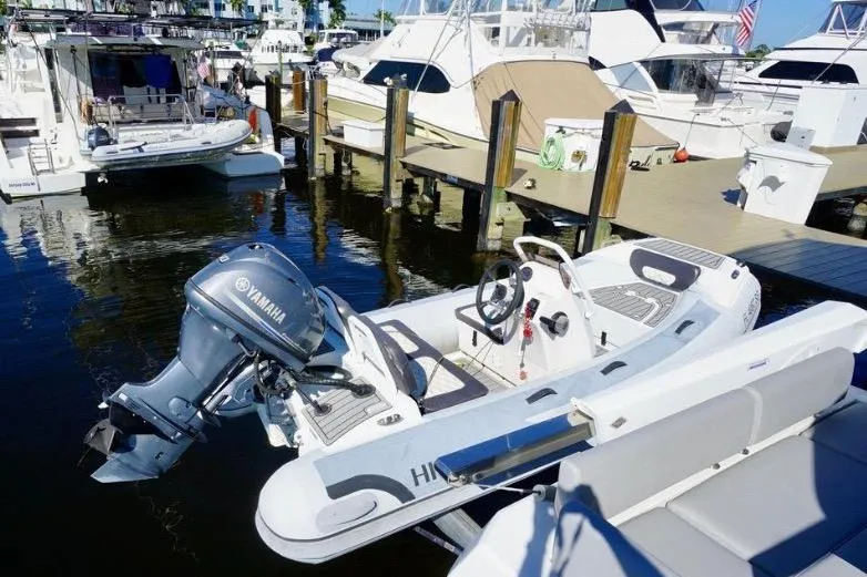 Slide: The Image of Aquila 44 Yacht 2020 docked with Yamaha-powered dinghy in marina. - 43