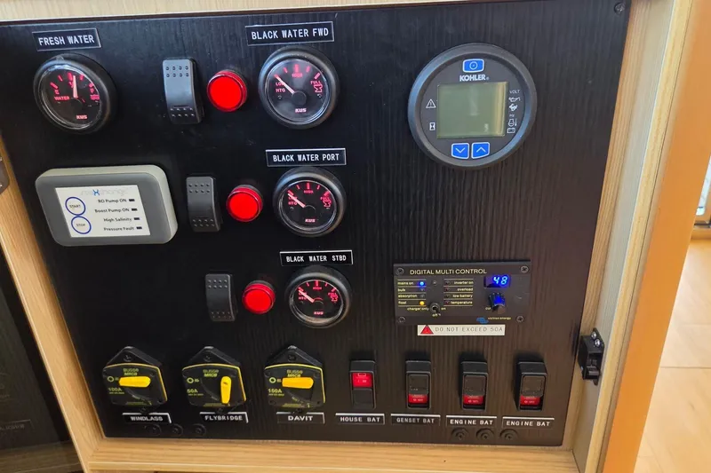 Slide: The Image of Control panel of a 2020 Aquila 44 Yacht with gauges and switches. - 48