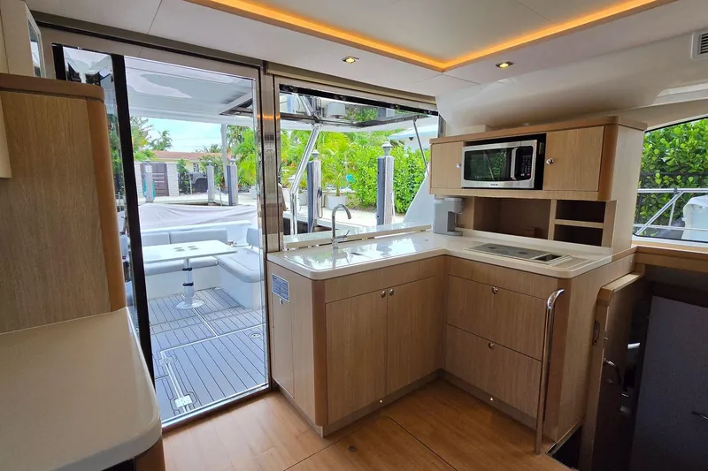 Slide: The Image of Interior of 2020 Aquila 44 Yacht featuring modern kitchen and outdoor seating area. - 7