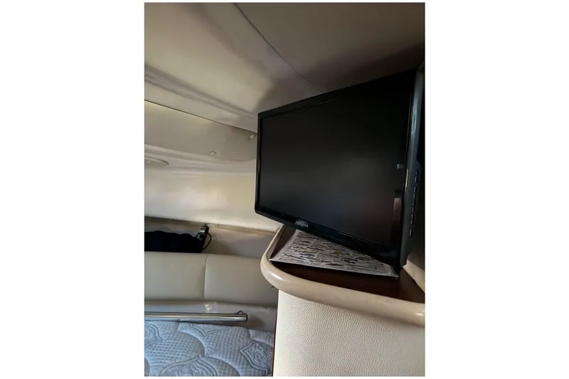 Slide: The Image of Interior of 2014 Robalo R265 Walkaround boat with mounted TV and cozy seating area. - 11