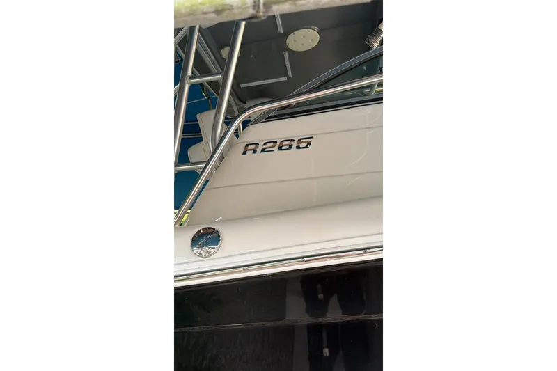 Slide: The Image of 2014 Robalo R265 Walkaround boat with sleek design and chrome details. - 5