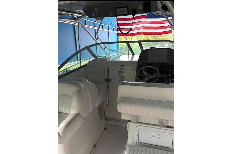 Slide: The Image of 2014 Robalo R265 Walkaround boat interior with American flag and steering wheel. - 8