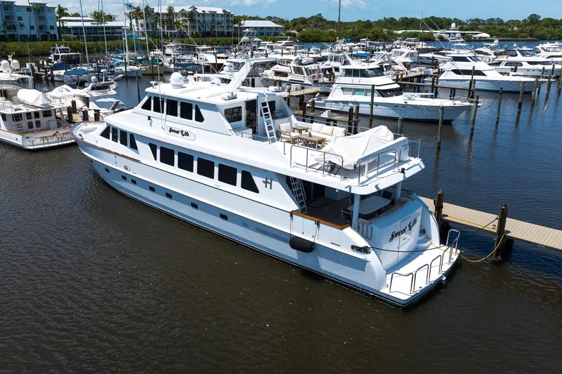 Slide: The Image of Luxury 2001 Hargrave 94 yacht docked at marina, surrounded by other boats. - 101
