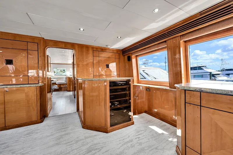 Slide: The Image of Luxurious interior of 2001 Hargrave 94 yacht with wooden cabinetry and large windows. - 18