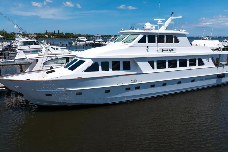 Slide: The Image of Luxury Hargrave 94 yacht from 2001 docked at a marina under a clear blue sky. - 3