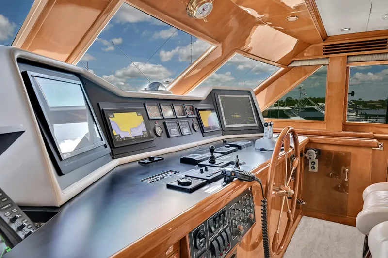 Slide: The Image of Luxurious Hargrave 94 yacht helm with advanced navigation systems, wooden accents, and panoramic windows. - 34