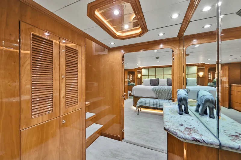 Slide: The Image of Luxurious Hargrave 94 yacht interior, featuring elegant wood paneling and a spacious bedroom, 2001 model. - 43