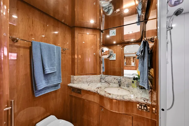 Slide: The Image of Luxurious yacht bathroom with wood paneling, granite countertop, and blue towels, Hargrave 94, 2001. - 49