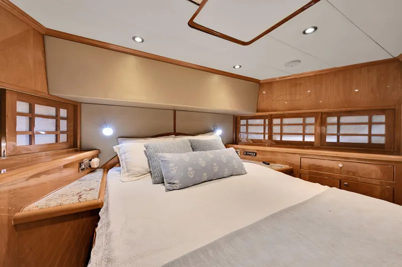Slide: The Image of Luxurious bedroom interior of a 2001 Hargrave 94 yacht with elegant wood finishes. - 54