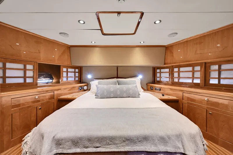Slide: The Image of Luxurious bedroom interior of a 2001 Hargrave 94 yacht with elegant wood finishes. - 55