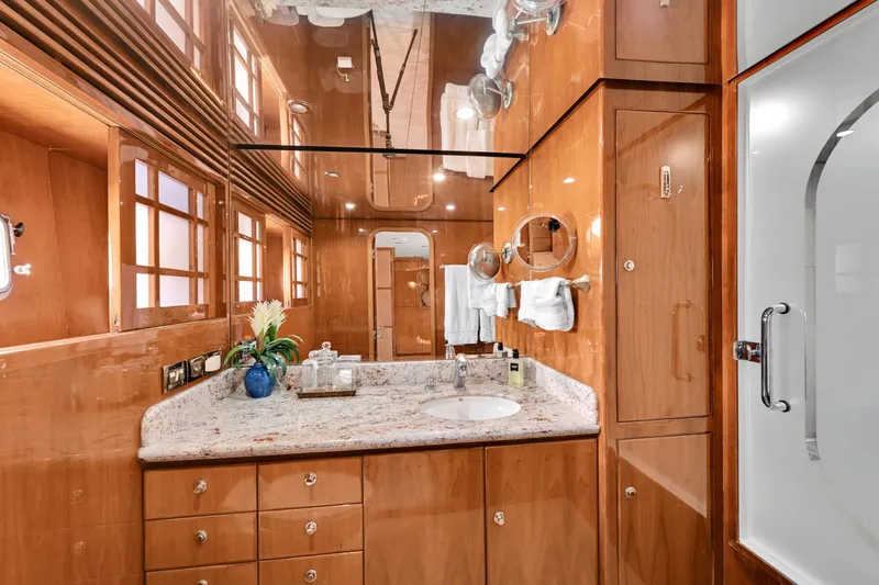 Slide: The Image of Luxurious yacht bathroom with wood paneling, granite countertop, and elegant fixtures on a 2001 Hargrave 94. - 62