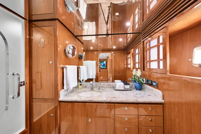 Slide: The Image of Luxurious bathroom interior on a 2001 Hargrave 94 yacht, featuring wood paneling and granite countertop. - 65