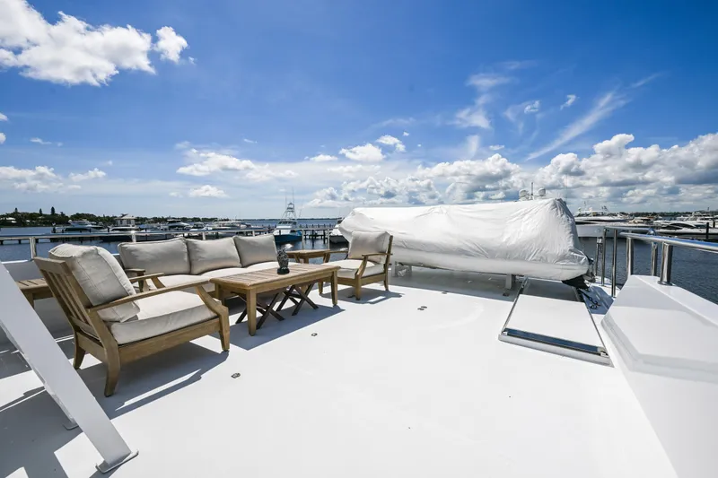 Slide: The Image of Luxurious deck of 2001 Hargrave 94 yacht with seating and ocean view. - 79