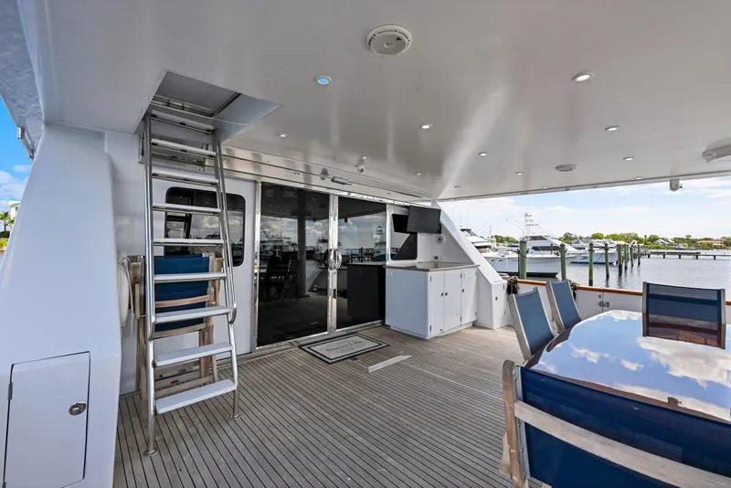 Slide: The Image of Spacious deck of 2001 Hargrave 94 yacht with seating and marina view. - 81