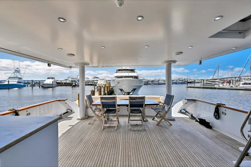 Slide: The Image of Luxurious 2001 Hargrave 94 yacht deck with marina view and seating area. - 85