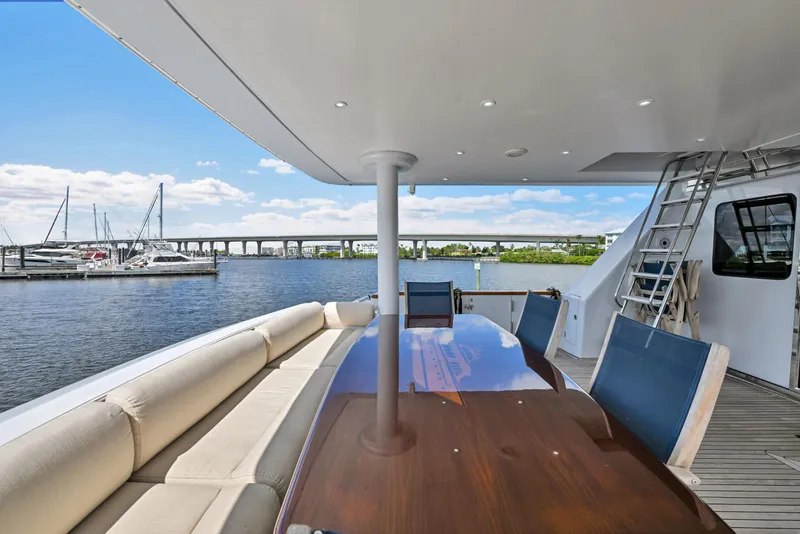 Slide: The Image of Luxury yacht deck with seating and table, overlooking marina and bridge. Hargrave 94, 2001 model. - 86