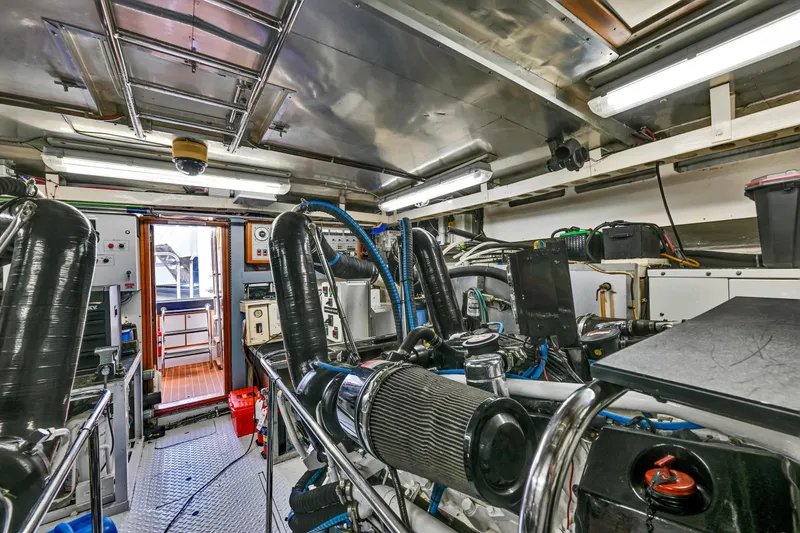 Slide: The Image of Engine room of a 2001 Hargrave 94 yacht, featuring complex machinery and equipment. - 93