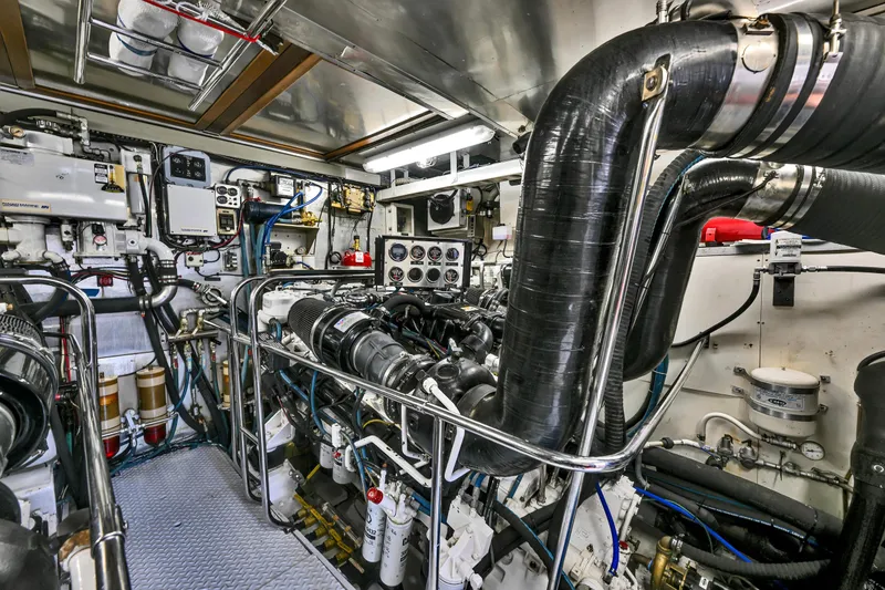 Slide: The Image of Engine room of a 2001 Hargrave 94 yacht, showcasing complex machinery and piping. - 96