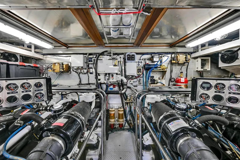 Slide: The Image of Engine room of a 2001 Hargrave 94 yacht, showcasing complex machinery and control panels. - 99